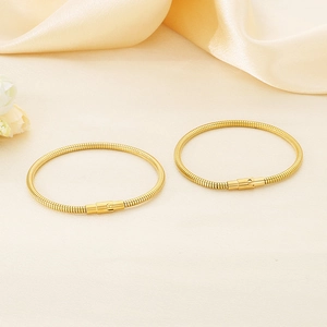 Elegant 18K gold plated snake chain stainless steel bangles set on soft yellow silk fabric