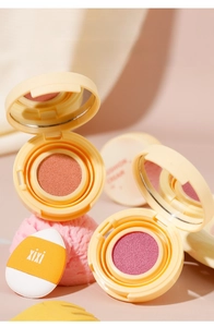 Macro view of cushion blush palette with sponge puff and mirror in peach and berry tones