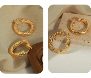 Detailed view of gold twisted hoop earrings with spiral texture on stone base