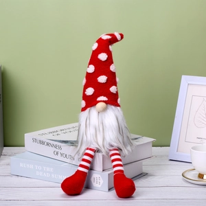 Christmas Swedish gnome doll with red and white polka dot hat sitting on books