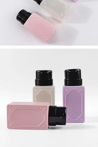 Macro view of vintage embossed plastic pump bottles for nail polish remover in macaron colors
