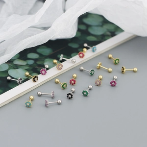 Detail view of colorful floral zircon screw back earrings in gold and silver plating