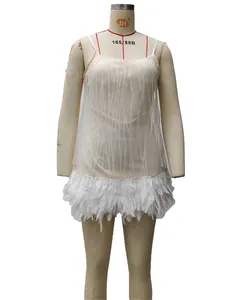 Detail of white mesh party dress featuring silver glitter stripes and white feather hem