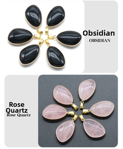 Detail view of obsidian and rose quartz teardrop pendants with gold plated edges