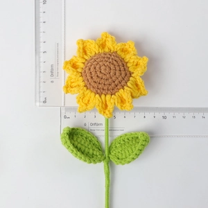 Handmade crochet sunflower with yellow petals and scale ruler showing 9.5cm diameter size