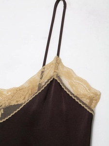 Detail of dark brown satin camisole with beige lace trim and delicate thin straps
