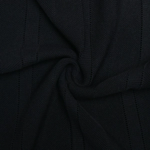 Close-up detail of the black ribbed knit fabric texture on the summer backless maxi dress