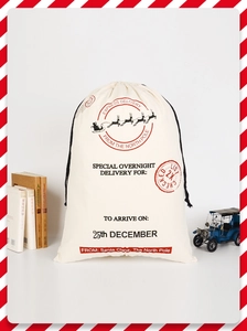 Detail of Christmas canvas drawstring gift bag with festive print and vintage props