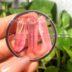 Silver metal hair clip with three pink iridescent natural crystals in a circular design