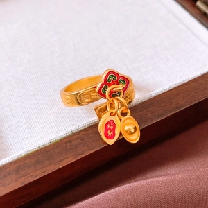 Macro detail of Chinese style gold ring with Ruyi and Yuanbao ingot lucky charms