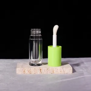 Detail of 6ml clear cosmetic tube with large sponge brush and vibrant green cap