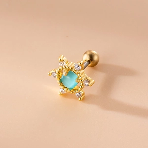 Detailed view of a gold star stud earring with a blue zircon center and ball screw back