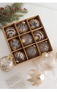 Detailed set of twelve clear champagne gold glitter Christmas ornaments in craft box