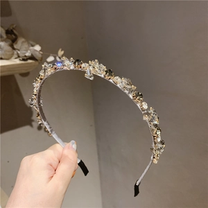 Close-up of sparkling crystals and smoke-gray gems on a slim luxury headband