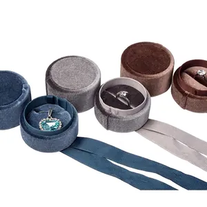 Round velvet jewelry boxes for rings and pendants with silk ribbons in multiple colors