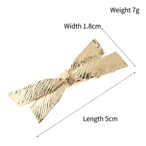 Elegant gold bow hair claw clip with matte brushed texture, 5cm length size display