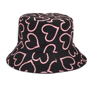 Détail d'un bob noir avec des motifs de cœurs roses et un tissu en coton doux