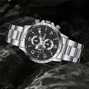 Macro view of MKUN men's chronograph watch with steel band on dark textured rock