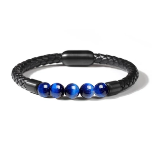 Close-up of black braided leather bracelet featuring blue tiger eye stones and magnetic clasp