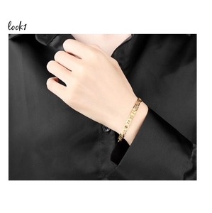 Close-up of a 18K gold plated copper link bracelet worn on a female wrist with black silk