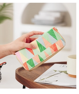 Detailed view of long PU leather wallet with colorful geometric pattern and gold zipper
