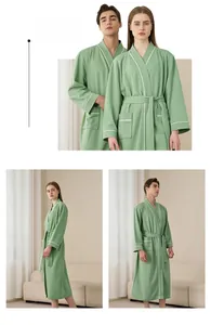 Close-up of green waffle weave bathrobe featuring soft cotton fabric and large pockets