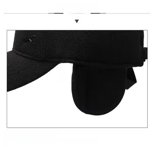 Detail of winter wool blend cap featuring protective ear flaps and a metallic K logo