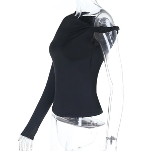 Detail of black one-shoulder top featuring asymmetric sleeve and shoulder twist knot