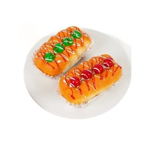 Realistic PU squishy bread toy with colorful toppings and paper liner on a plate