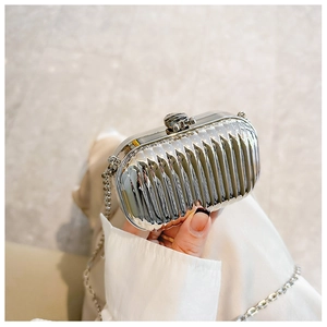 Detail shot of silver mirror acrylic clutch with vertical stripes and metal chain