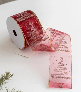 Detail of red sheer organza Christmas ribbon with gold and silver glitter tree patterns