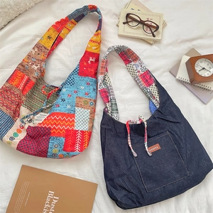 Detailed close-up of ethnic patterned corduroy and denim tote bags on a beige surface