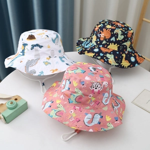 Detailed view of three cotton kids sun hats with cartoon dinosaur prints and adjustable chin straps