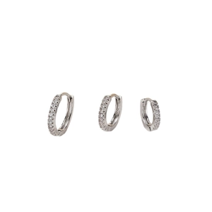 Three-piece set of silver hoop earrings with shimmering zircons for women
