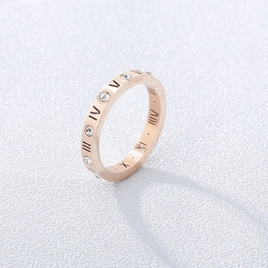 Macro view of rose gold Roman numeral ring with sparkling crystal stone inlays