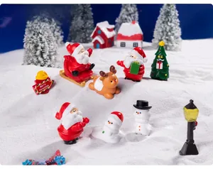 Miniature resin Santa Claus and reindeer figurines set in a festive winter snow scene