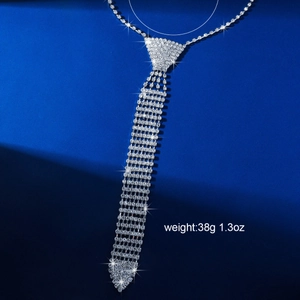 Elegant silver tassel tie necklace with sparkling rhinestones on a dark blue background