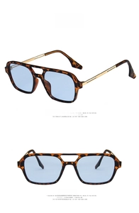 Detail view of retro leopard print frame sunglasses with blue lenses and double bridge