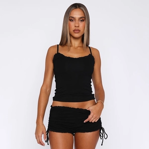 Detail of black camisole set featuring side drawstring cinch on the shorts