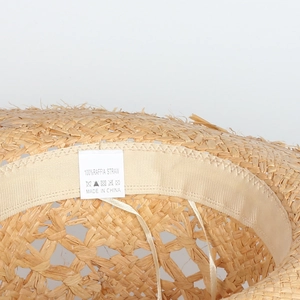 Detail of adjustable inner sweatband and raffia straw weave on bohemian beach hat