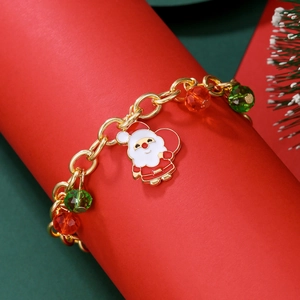 Gold Christmas bracelet with Santa Claus charm and festive red and green faceted beads