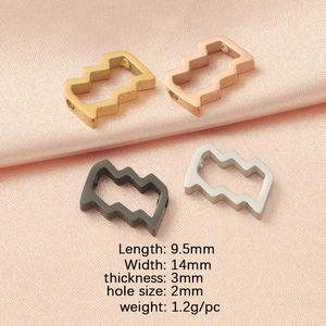 Hollow zodiac beads in gold silver black rose gold with size specs on pink silk