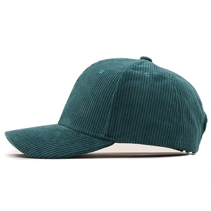 Detail view of corduroy baseball cap in deep forest green with six-panel construction