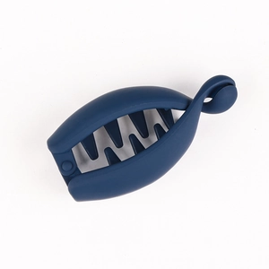 Macro detail of dark blue matte banana hair clip showing its shark tooth grip texture