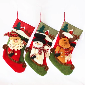 Three plush Christmas stockings with 3D Santa, Snowman and Reindeer on white background