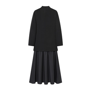 Back view of a black long-sleeved blazer dress with pleated skirt and slim fit design