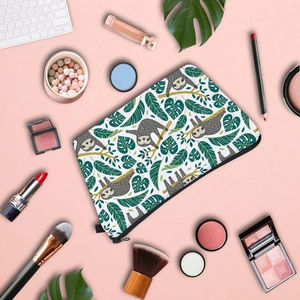 Sloth and tropical leaf print makeup bag with zipper on pink aesthetic background