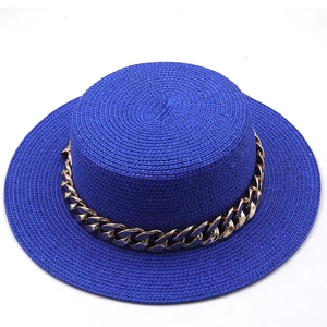 Detail view of woven blue straw boater hat featuring a stylish thick gold metal chain band