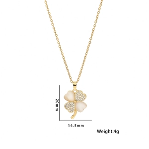 Golden titanium four-leaf clover necklace with sparkling rhinestones and cat-eye stone