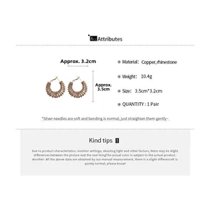 Detail view of woven rhinestone hoop earrings with copper material and size measurements
